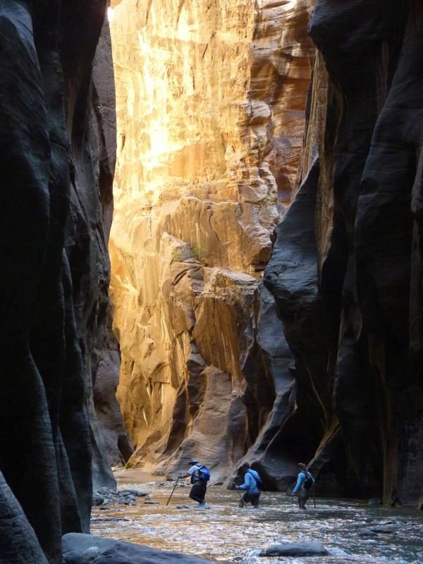 Hikers travel through The Narrows.